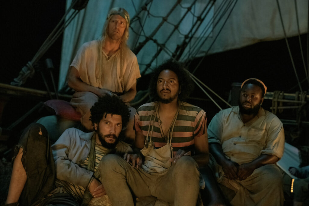 Joel Fry, Nat Faxon, Samba Schutte, and Samson Kayo in David Jenkins's HBO Max period comedy adventure swashbuckler series, Our Flag Means Death, Season 1 Episode 6 