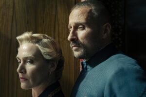 Kate Winslet as Chancellor Elena Vernham and Matthias Schoenaerts as Corporal Herbert Zubak in Will Tracy's HBO political drama satire limited series, The Regime