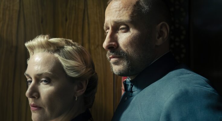 Kate Winslet as Chancellor Elena Vernham and Matthias Schoenaerts as Corporal Herbert Zubak in Will Tracy's HBO political drama satire limited series, The Regime