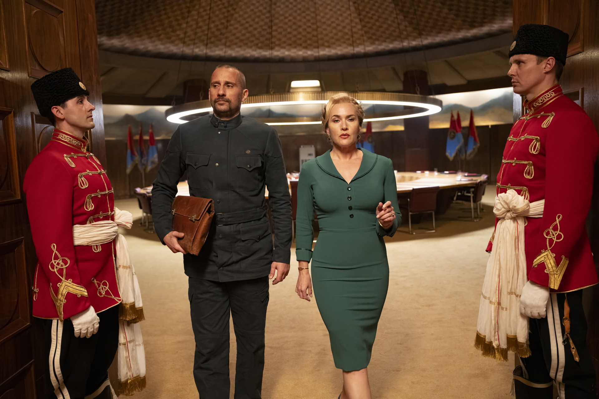 Matthias Schoenaerts as Corporal Herbert Zubak and Kate Winslet as Chancellor Elena Vernham in Will Tracy's HBO political drama satire limited series, The Regime