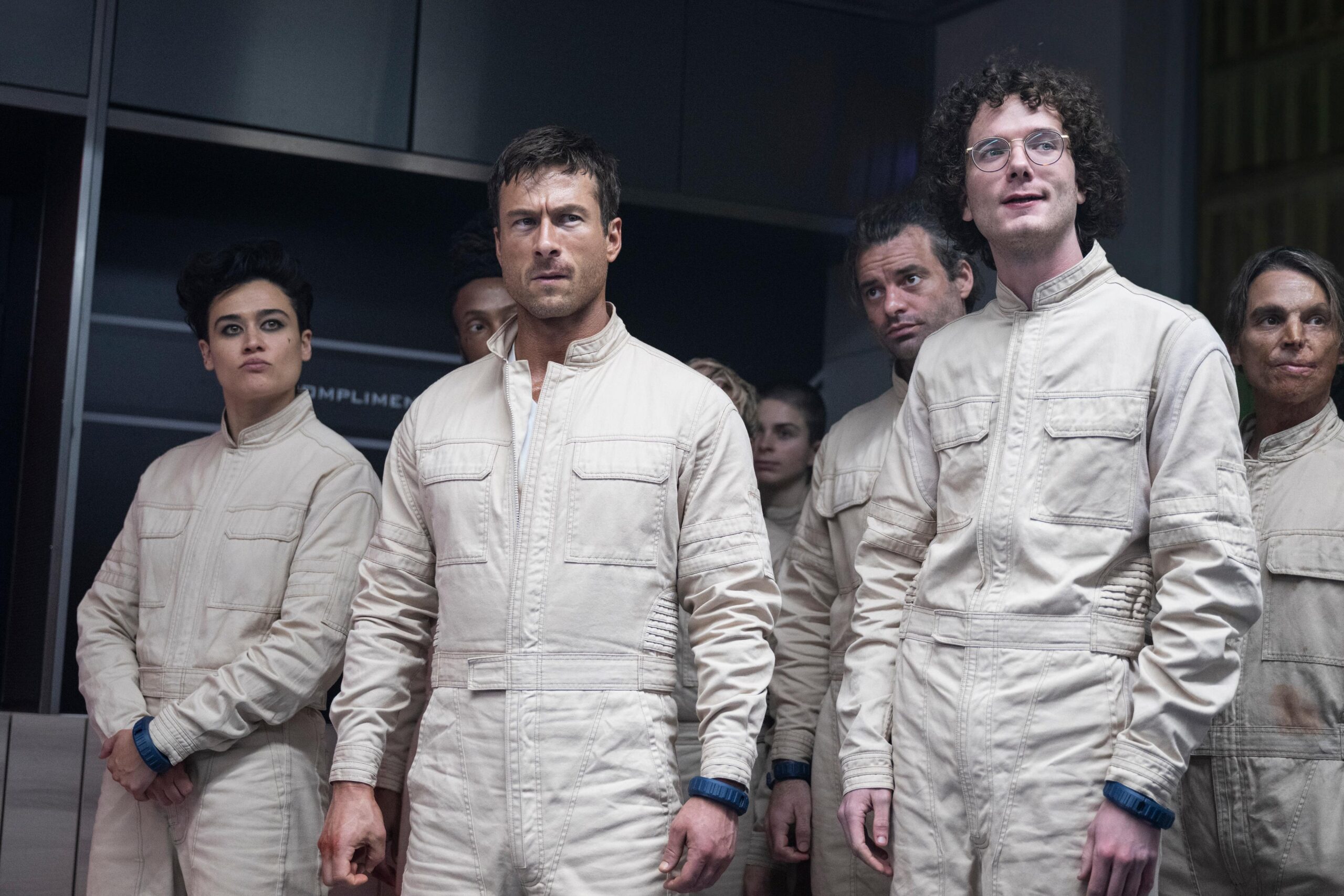Katy O'Brian, Glen Powell, and Martin Herlihy in Edgar Wright and Michael Bacall's action adventure dark comedy science fiction dystopian thriller film adaptation, The Running Man